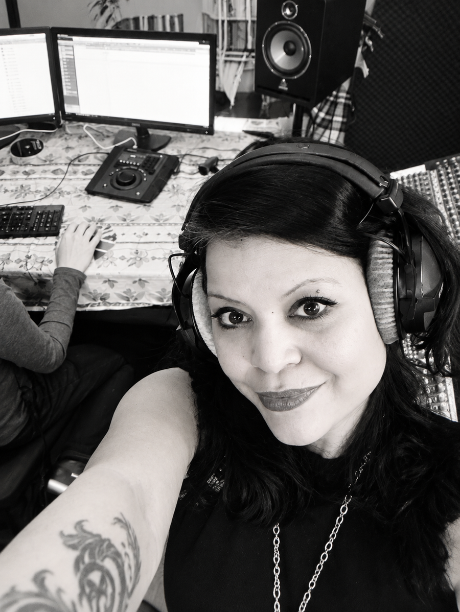 Natalie wearing headphones in a recording studio.