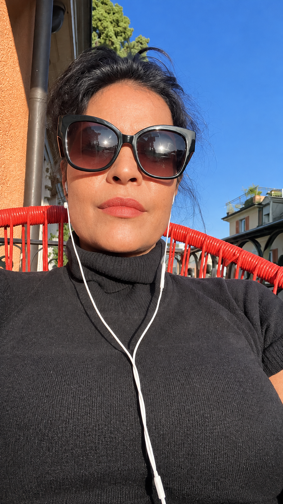 Natalie wearing sunglasses outdoors in sunlight.