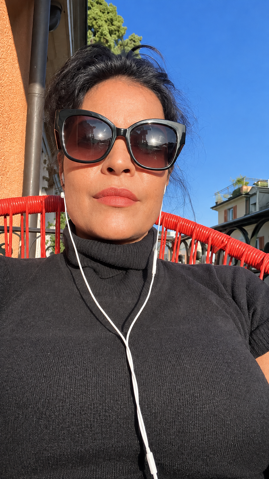 Natalie wearing sunglasses outdoors in sunlight.
